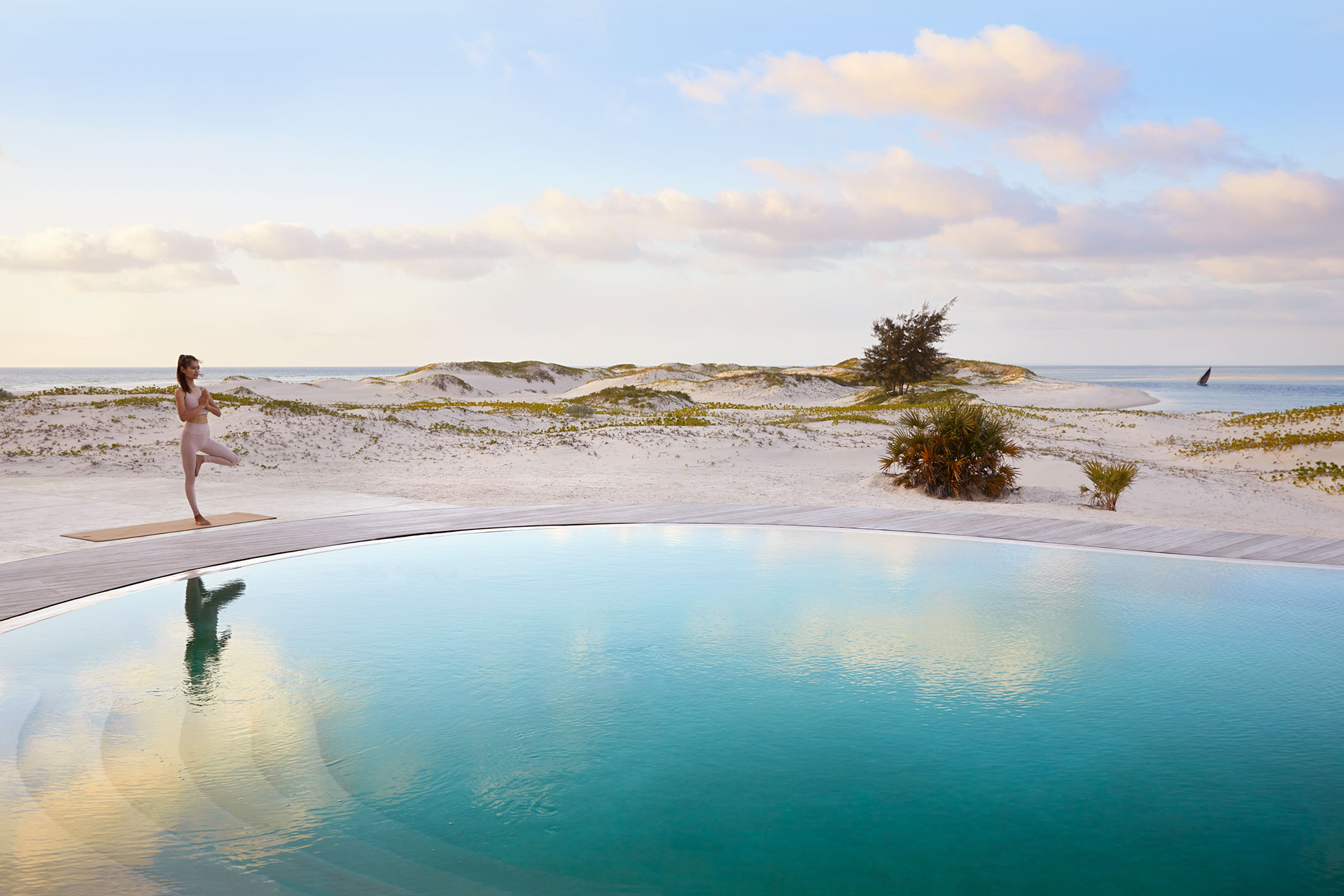 Women doing Yoga by some water