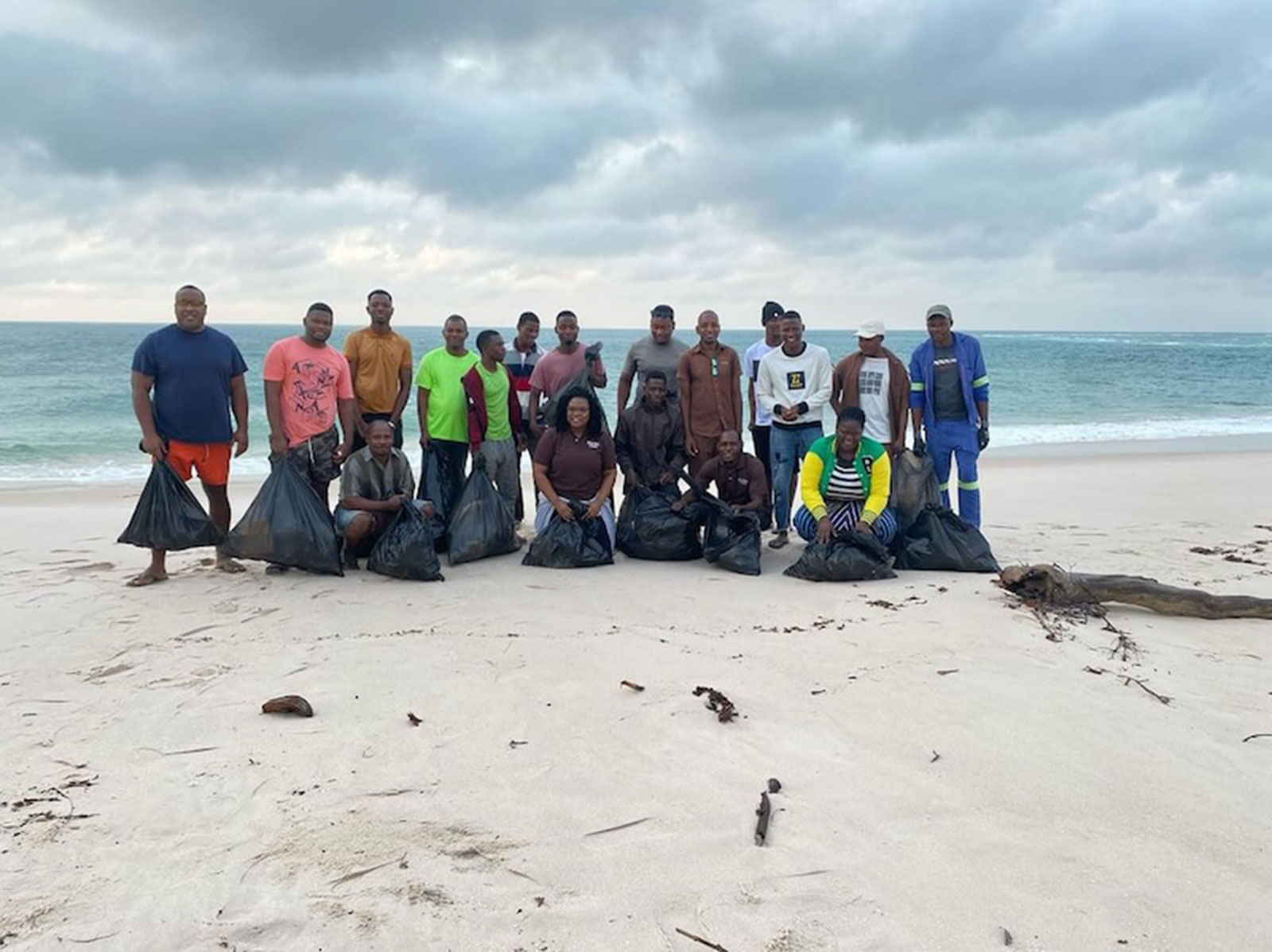 Group of litter pickers on Benguerra Island beach